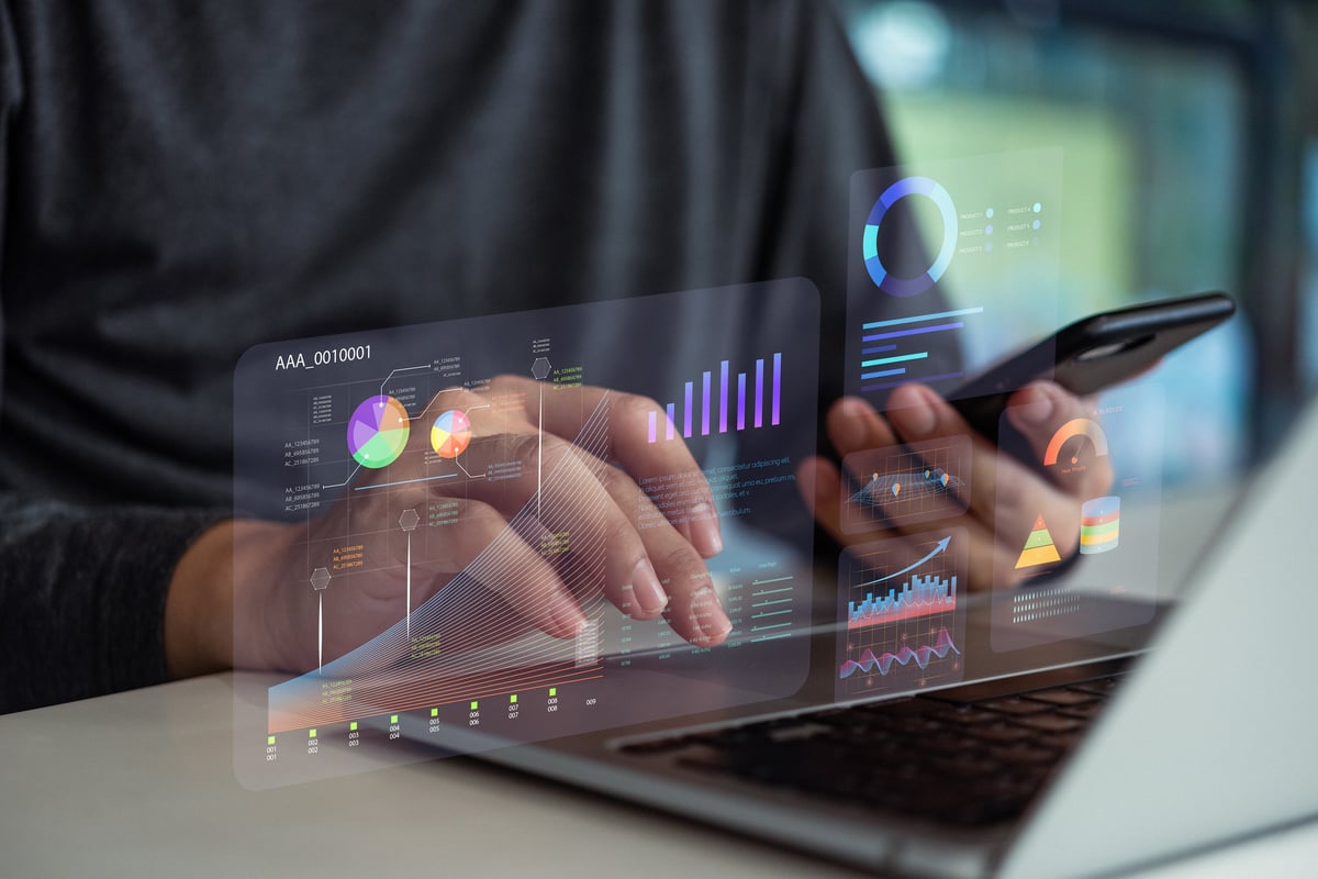 Hands analyzing data digital dashboards with charts and graphs