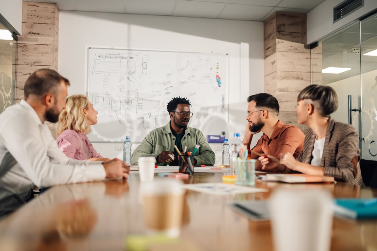 Diverse marketing team discussing and strategizing in modern office